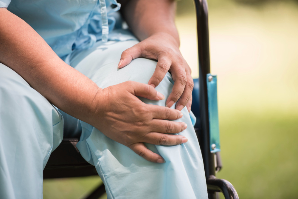 Elderly woman sitting on wheelchairs with joint pain